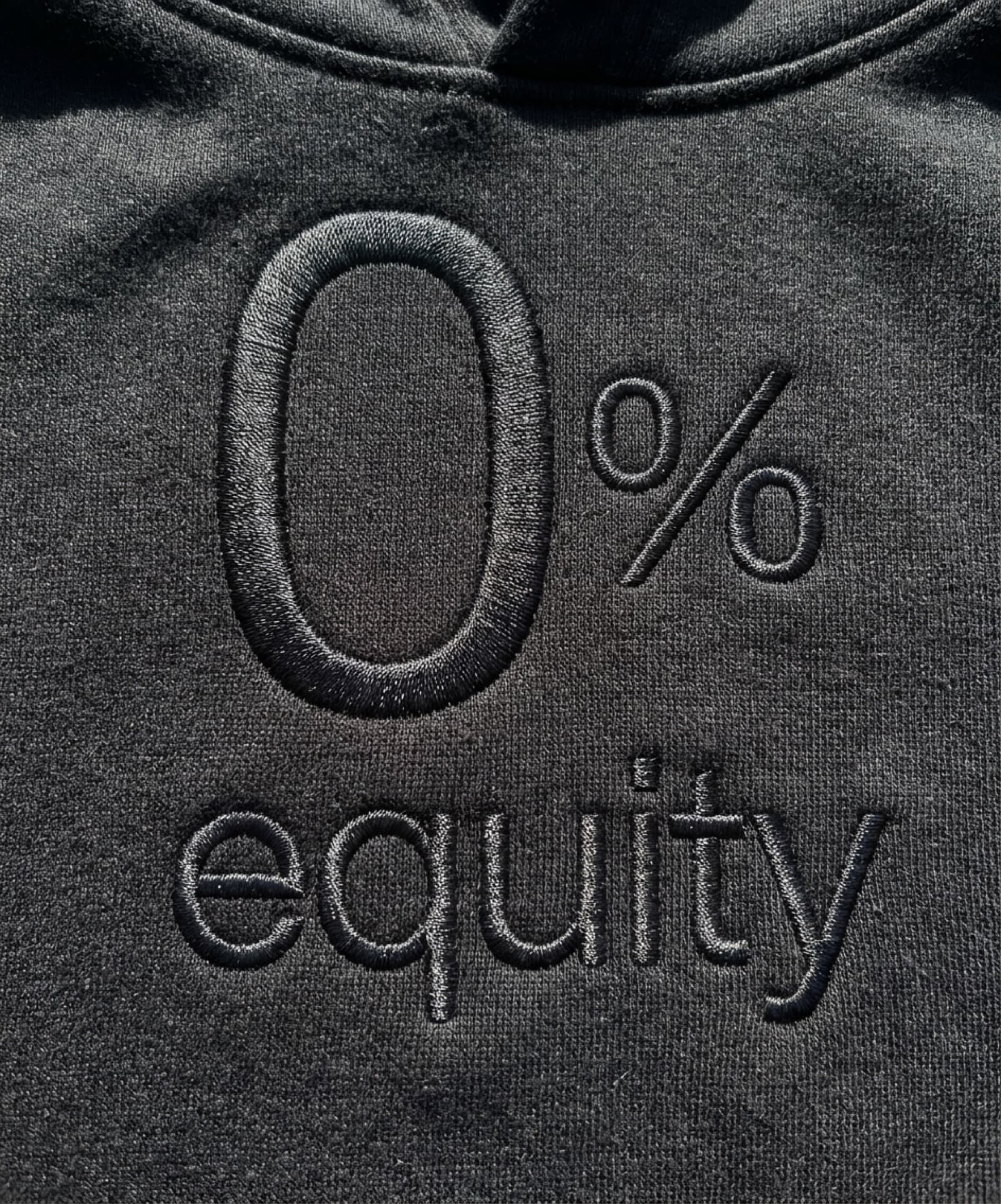 0% equity embroidered on a black hoodie